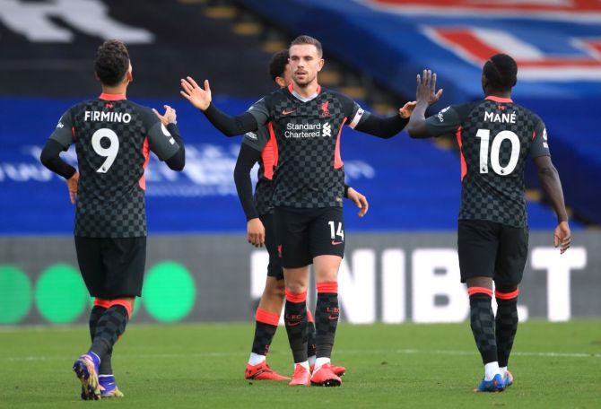 Liverpool's Jordan Henderson celebrates scoring their fourth goal with Sadio Mane and Roberto Firmino 