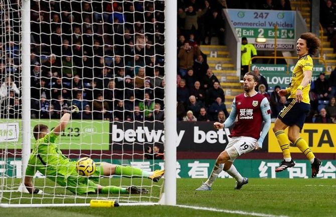 Burnley's Jay Rodriguez watches the ball bounce on the goal line after shooting against the crossbar.