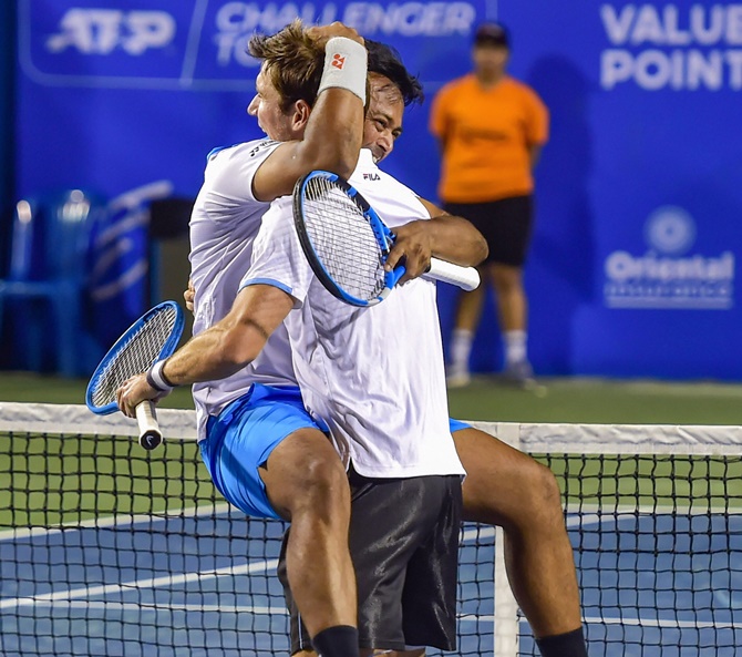 Leander Paes and Australia’s Matthew Abden celebrate after making the doubles semi-finals at the Bengaluru Open on Thursday