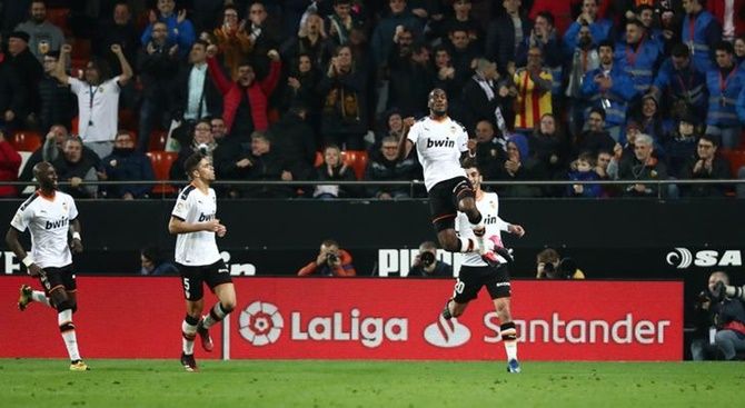 Geoffrey Kondogbia celebrates scoring Valencia's second goal with teammates.