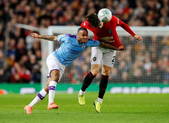 Manchester City's Raheem Sterling and Manchester United's Victor Lindelof vie for the ball