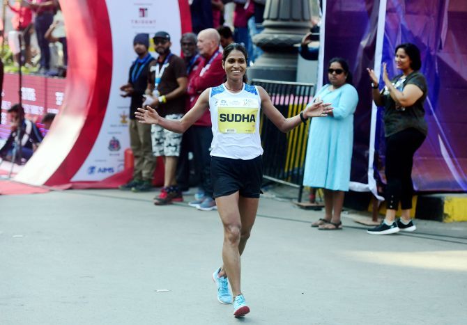 India's elite athlete Sudha Singh celebrates on crossing the finish line to win the gold medal in the Tata Mumbai Marathon 2020 (elite class), in Mumbai, Sunday