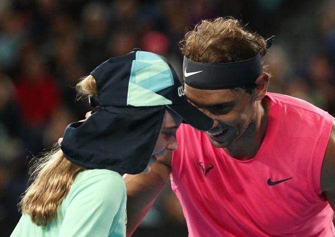 Spain's Rafael Nadal speaks with a ball girl after she is struck by the ball during the match against Argentina's Federico Delbonis.