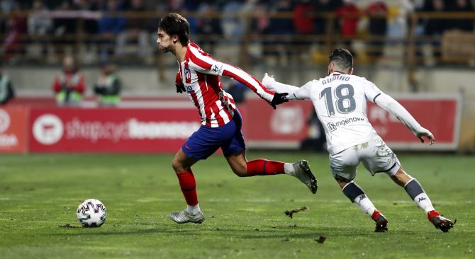 Atletico Madrid's Angel Correa is challenged by Cultural Leonesa's Gudino during their Copa del Rey match on Thursday