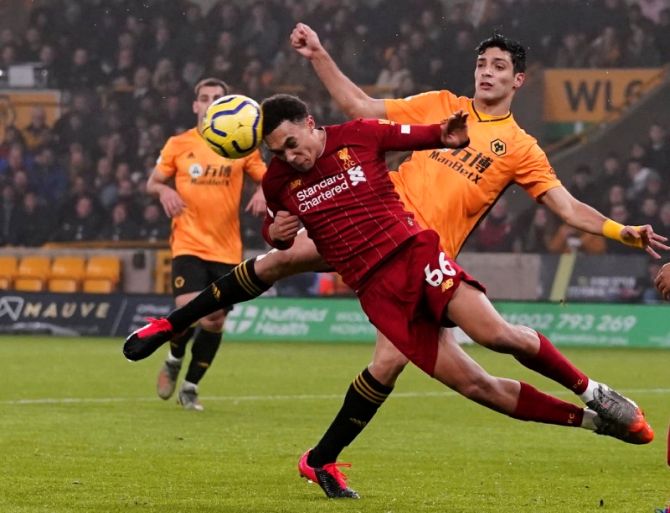 Liverpool's Trent Alexander-Arnold wins the ball as he vies with Wolverhampton Wanderers' Raul Jimenez
