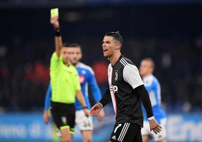 Juventus' Cristiano Ronaldo is shown the yellow card by referee Maurizio Mariani.