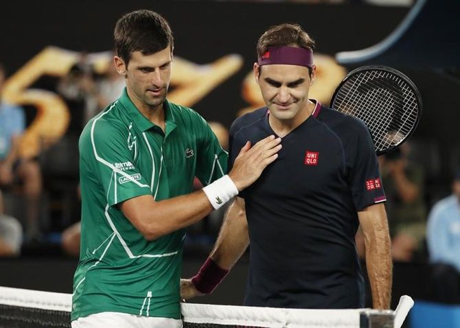 Serbia's Novak Djokovic pats Switzerland's Roger Federer after winning their men's singles semi-final at the Australian Open on Thursday.