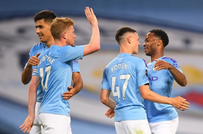 Manchester City's Raheem Sterling celebrates scoring their fourth goal with teammates at the Etihad Stadium in Manchester