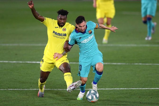 Barcelona's Lionel Messi is challenged by Villarreal's Andre-Frank Zambo Anguissa