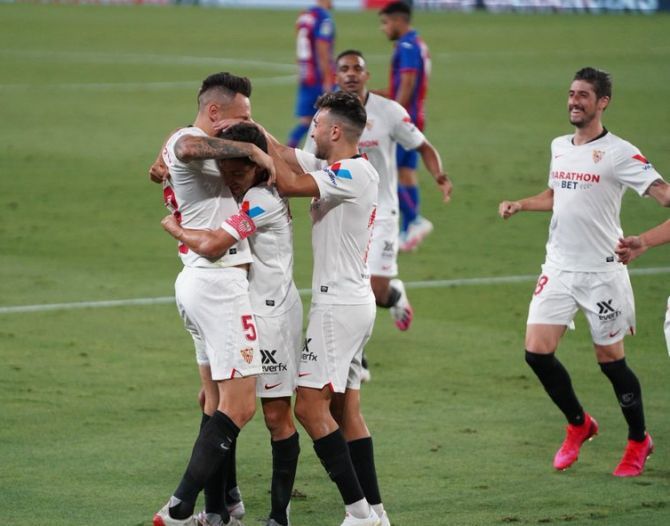 Sevilla players celebrate a goal against Eibar during their La Liga match on Monday