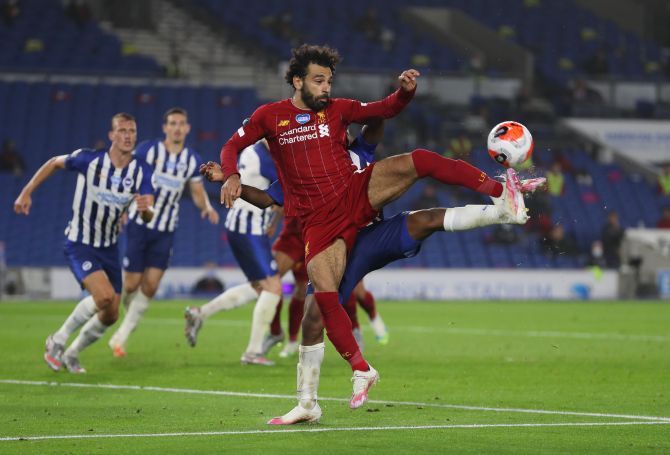 Liverpool's Mohamed Salah wins the ball in a challenge against a Brighton player during their English Premier League match at The American Express Community Stadium, Brighton, Britain. 