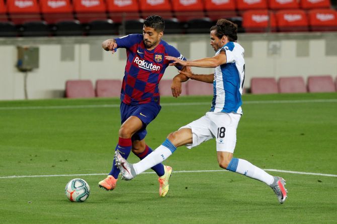 Barcelona's Luis Suarez is challenged by Espanyol's Leandro Cabrera during their La Liga match at Camp Nou, Barcelona, on Wednesday 