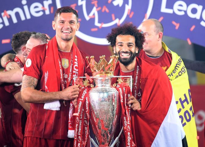 Liverpool's Dejan Lovren and Mohamed Salah celebrate with the trophy 