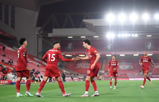  Liverpool's Alex Oxlade-Chamberlain celebrates scoring their fifth goal with Roberto Firmino