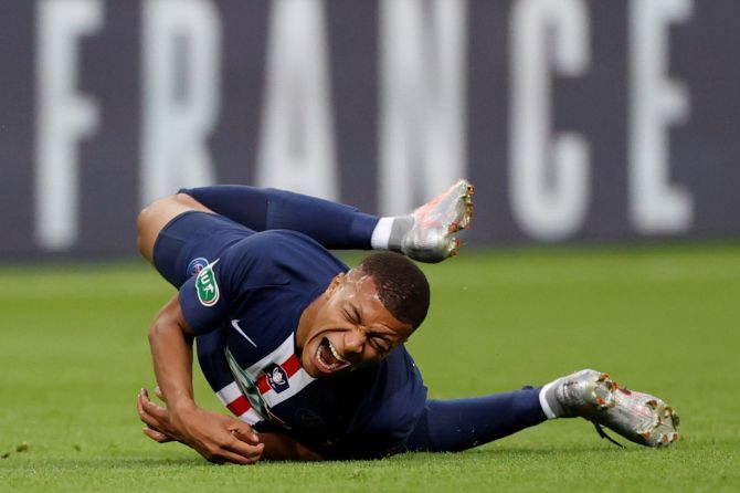 Paris St Germain's Kylian Mbappe reacts after sustaining an injury following a rough tackle by Loic Perrin 
