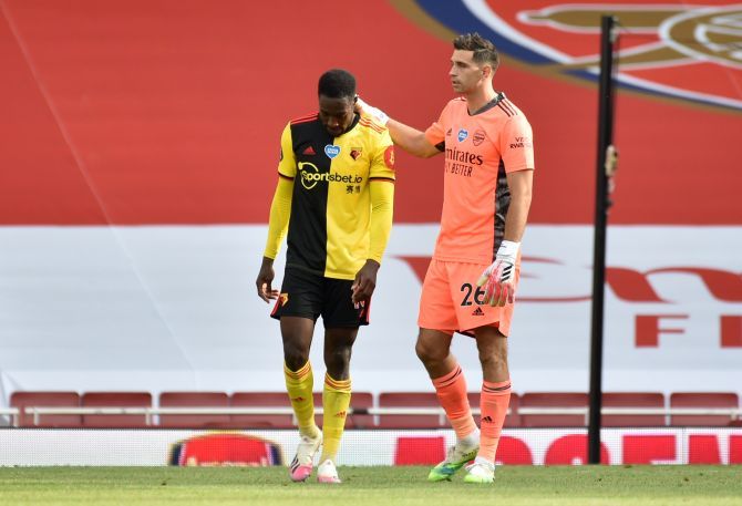 Watford's Danny Welbeck is consoled by Arsenal's Emiliano Martinez at the end of the match at Emirates Stadium after Watford are relegated from the Premier League