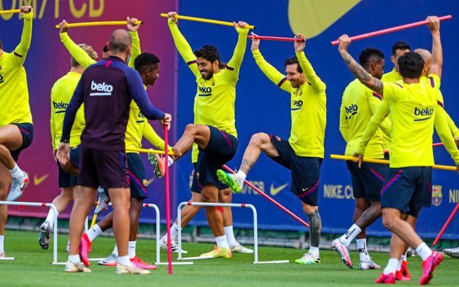 FC Barcelona's Lionel Messi and Luis Suarez go through the paces with teammates during a training session on Monday