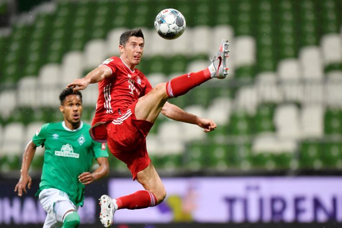 Bayern Munich's Robert Lewandowski goes airborne as he gets possession