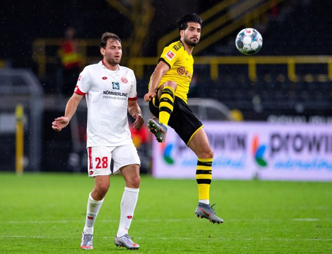 Borussia Dortmund's Emre Can and 1. FSV Mainz 05's Adam Szalai vie for possession during their Bundeliga match at Signal Iduna Park, Dortmund