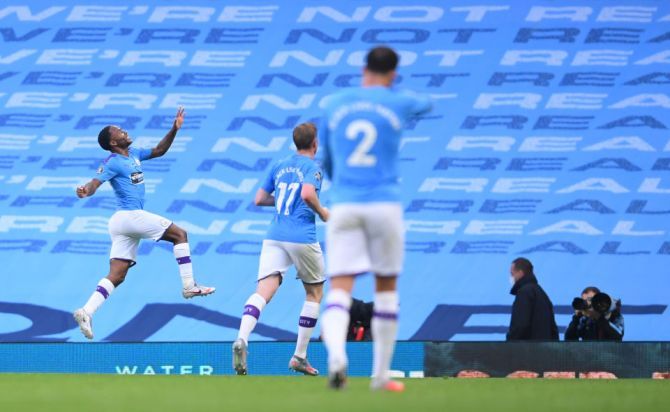Manchester City's Raheem Sterling celebrates after scoring the opening goal against Arsenal FC during their EPL match at Etihad Stadium in Manchester