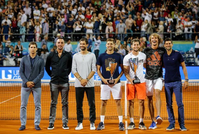 Austria's Dominic Thiem and runner-up Serbia's Filip Krajinovic pose with their trophies after the final match along with Dusan Lajovic of Serbia, Viktor Troicki of Serbia, Grigor Dimitov of Bulgaria, Alexander Zverev of Germany, and Novak Djokovic of Serbia at the Adria Tour charity exhibition hosted by Novak Djokovic in Belgrade, Serbia, on June 14, 2020. With both Serbia and Croatia easing lockdown measures weeks before the event, players were not obliged to observe social distancing rules in either country.