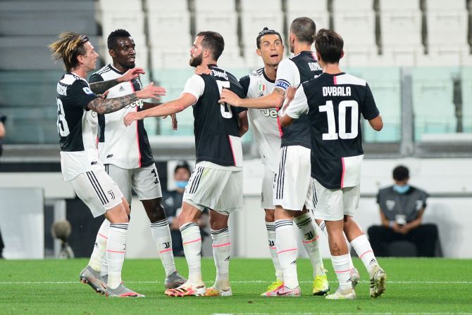 Juventus' Cristiano Ronaldo celebrates with teammates after scoring their second goal from the penalty spot during their Serie A match against Lecce at Allianz Stadium, Turin 