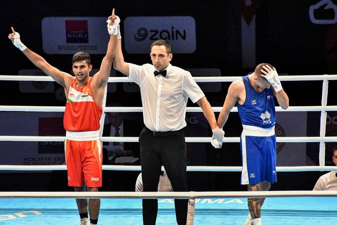 India's Manish Kaushik celebrates qualifying for the Tokyo Olympics after beating Australia's Harrison Garside in a brutal box-off during the Asian Qualifiers, at Amman in Jordan, on Wednesday.
