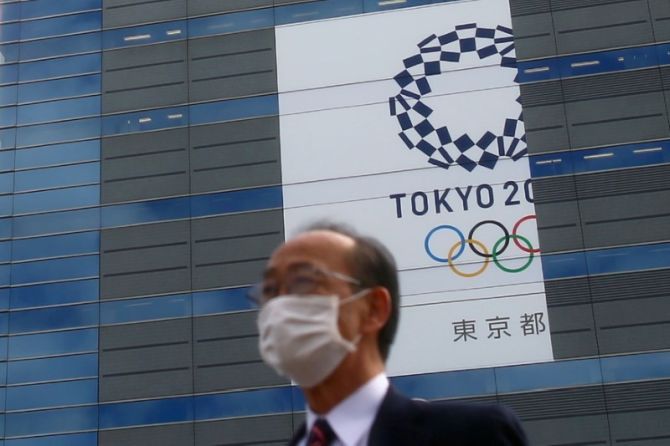 A man, wearing a protective mask following an outbreak of the coronavirus disease (COVID-19) is pictured in front of a banner for the upcoming Tokyo 2020 Olympics in Tokyo, Japan, on March 12, 2020. (Image used for representational purposes)