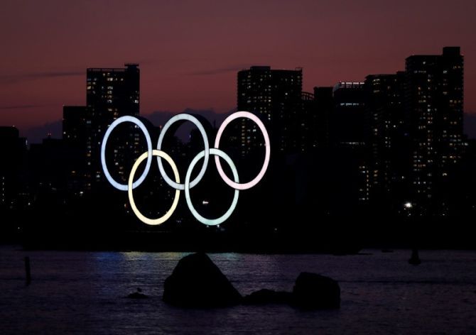 The giant Olympic rings are seen in the dusk at the waterfront area at Odaiba Marine Park in Tokyo, Japan
