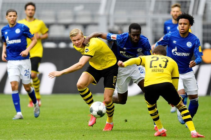 Dortmund's Erling Braut Haaland and Schalke's Salif Sane, vie for possession during their Bundeliga match on Saturday
