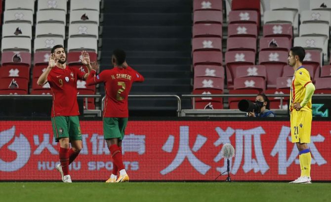 Portugal's Paulinho celebrates scoring their second goal with Nelson Semedo during their international friendly against Andorra at Estadio da Luz stadium in Lisbon