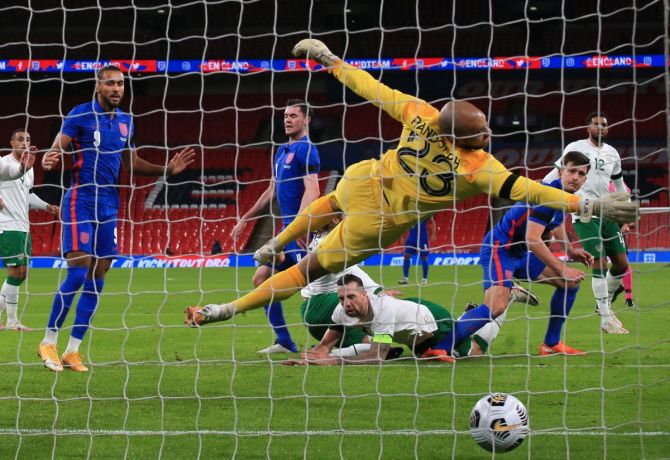England's Harry Maguire scores their first goal over Republic of Ireland at Wembley Stadium in London on Thursday