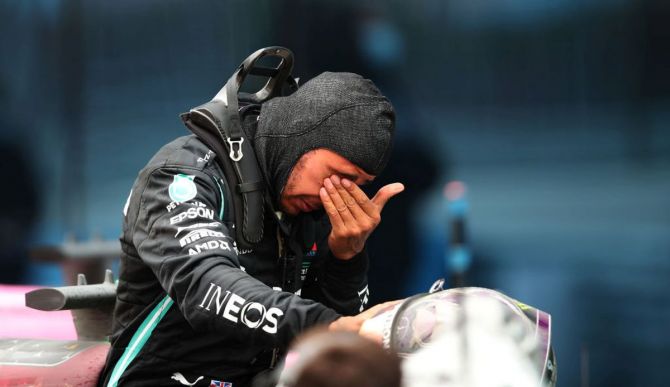 Mercedes GP's Lewis Hamilton wipes his tears as he celebrates winning a 7th F1 World Drivers Championship in parc ferme at the F1 Grand Prix of Turkey at Intercity Istanbul Park in Istanbul, Turkey, on Sunday