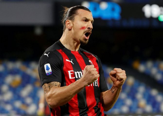 AC Milan’s Zlatan Ibrahimovic celebrates scoring their first goal while wearing red face paint to raise awareness of domestic violence against women in their match against Napoli on Sunday