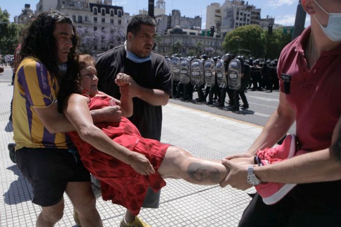 A woman faints during clashes between some fans and riot police 