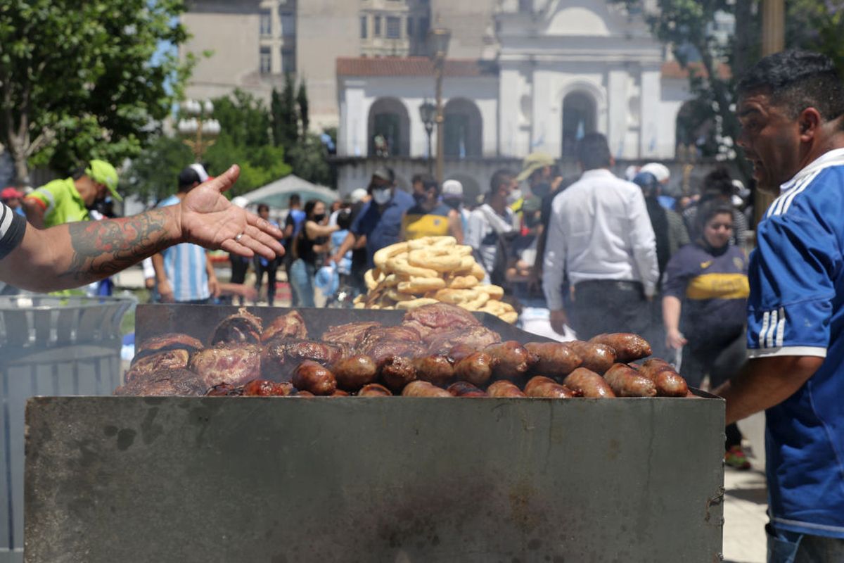 A street vendor offers sausage and meat during Diego Maradona's funeral in Buenos Aires on Thursday