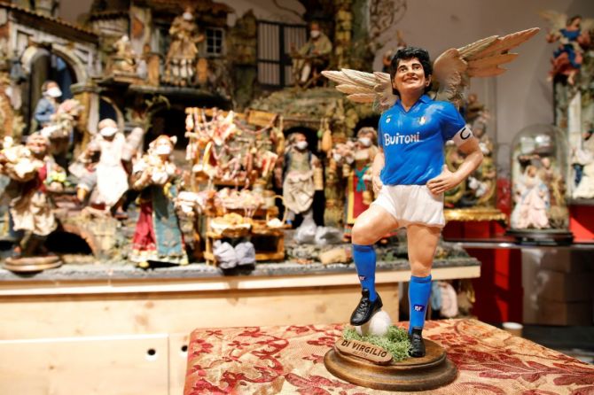 A figurine depicting late soccer legend Diego Maradona with angel wings is pictured the day after his death at a shop on Via San Gregorio Armeno, the famous street in Naples dedicated to producing nativity figurines, in Naples