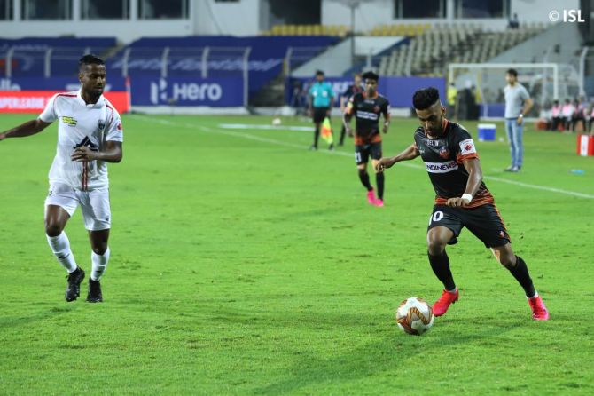 FC Goa's Brandon Fernandes (right) looks to pass the ball past a NEUFC player during their ISL match on Monday 