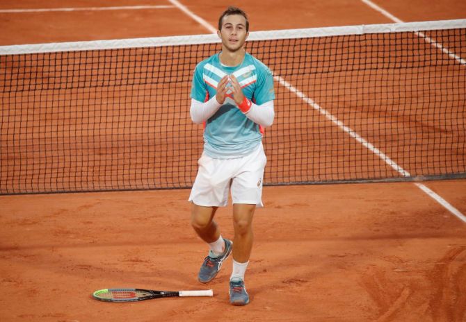 France's Hugo Gaston celebrates winning his French Open third round match against Switzerland's Stan Wawrinka at Roland Garros in Paris on Friday