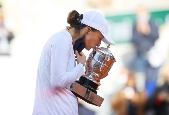  Poland's Iga Swiatek kisses the Suzanne-Lenglen Cup following victory over Sofia Kenin of the United States in the women's singles final at the French Open