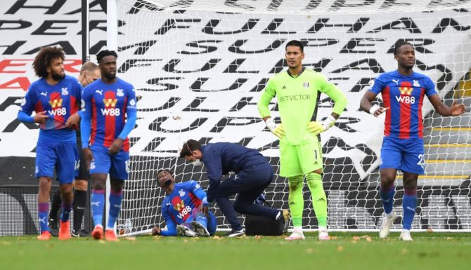 Wilfried Zaha receives medical assistance after getting injured while scoring Crystal Palace's second goal 
