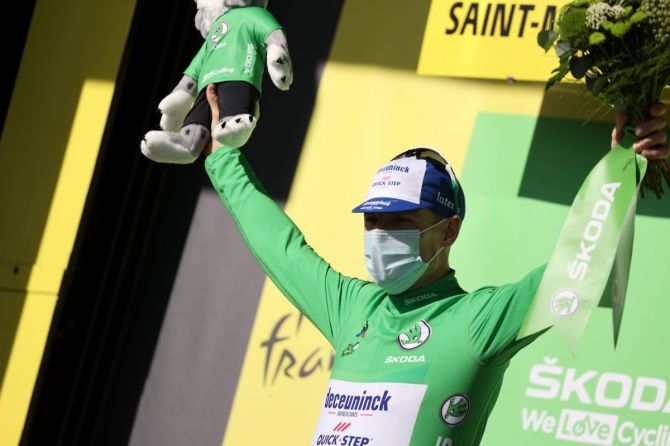 Deceuninck-Quick Step rider Sam Bennett of Ireland, wearing the green jersey, celebrates on the podium after winnning Stage 10 - Ile d'Oleron to Ile de Re at the Tour de France, on Tuesday