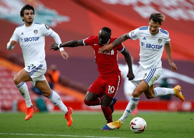 Leeds United's Robin Koch is challenged by Liverpool's Sadio Mane 
