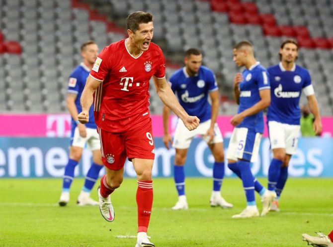 Bayern Munich's Robert Lewandowski scores their third goal against Schalke 04 during their Bundesliga match at Allianz Arena in Munich on Friday