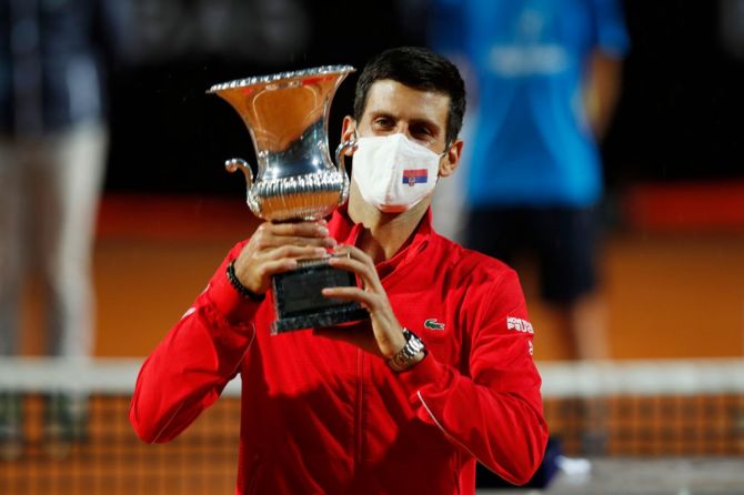 Serbia's Novak Djokovic hoists the trophy after winning the men's final against Argentina's Diego Schwartzman at the Internazionali BNL d'Italia, at Foro Italico.