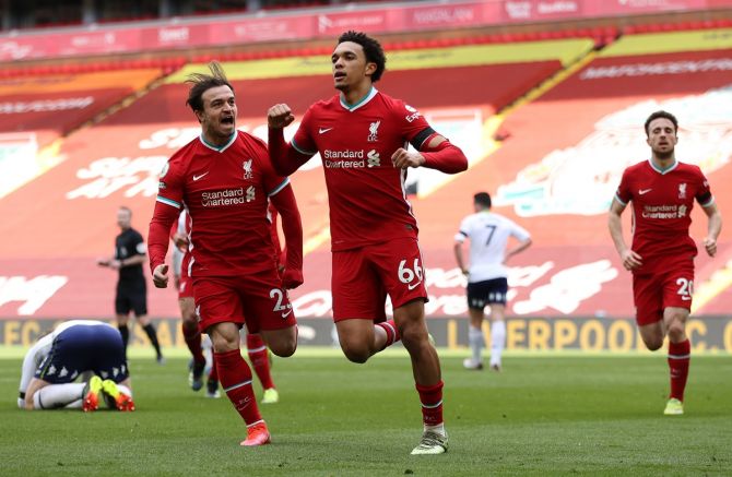 Trent Alexander-Arnold celebrates with teammate Xherdan Shaqiri after scoring Liverpool's second goal in stoppage time during the Premier League match against Aston Villa