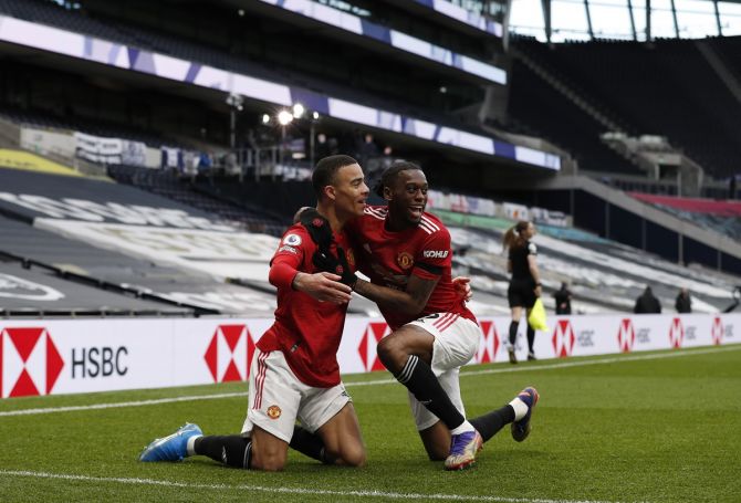 Mason Greenwood celebrates with Aaron Wan-Bissaka after scoring Manchester United's third goal in added time.