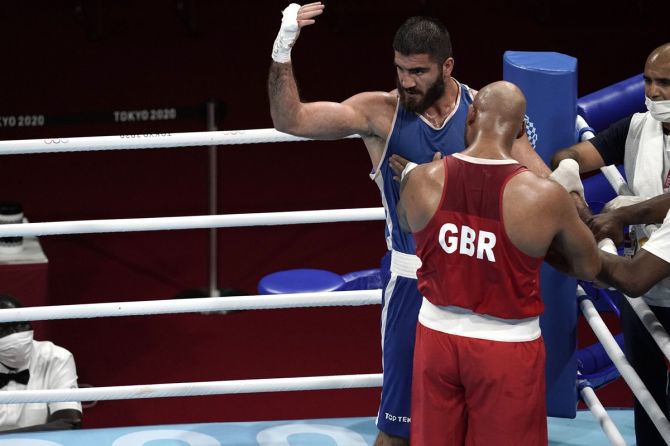 France's Mourad Aliev), blue shorts, yells at officials after being disqualified from his Olympics men's Super Heavyweight quarter-final bout against Great Britain's Frazer Clarke