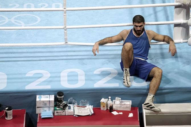 France's Mourad Aliev refuses to leave the ring after being disqualified in his men's Super-Heavyweight quarter-final bout against Great Britain's Frazer Clarke