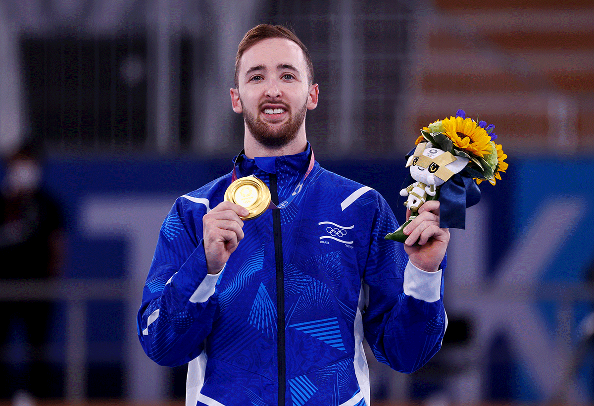 Gold medallist Artem Dolgopyat of Israel celebrates on the podium with his medal after winning the Artistic Gymnastics Men's Floor Exercise final at Ariake Gymnastics Centre, Tokyo, on Sunday